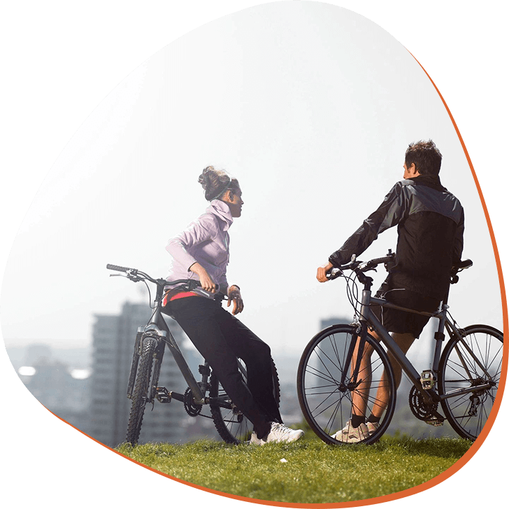 Two people standing with Bicycle and talking